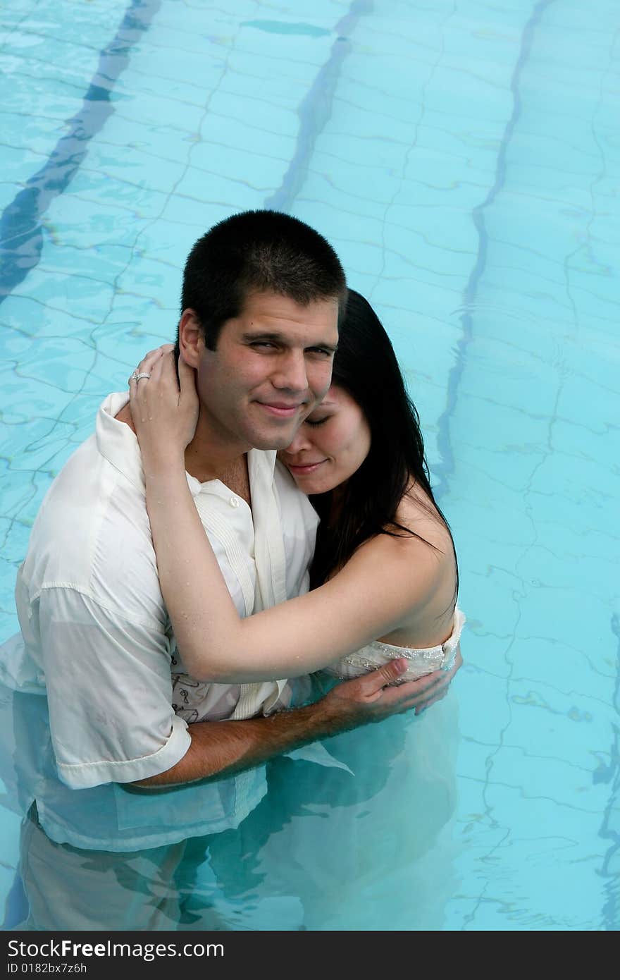 Bride and groom in the swimming pool - trash the dress trend. Bride and groom in the swimming pool - trash the dress trend.