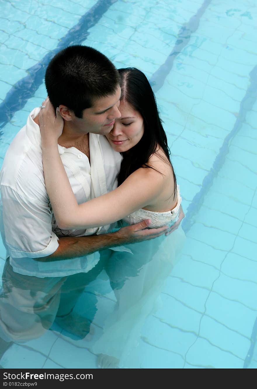 Bride and groom in the swimming pool - trash the dress trend. Bride and groom in the swimming pool - trash the dress trend.