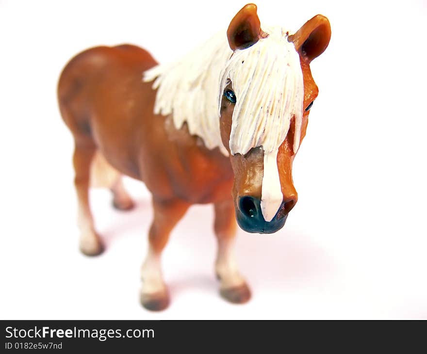 Close up of the plastic toy horse isolated on white background. Close up of the plastic toy horse isolated on white background.