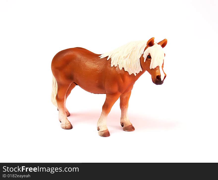 Close up of the plastic toy horse isolated on white background. Close up of the plastic toy horse isolated on white background.