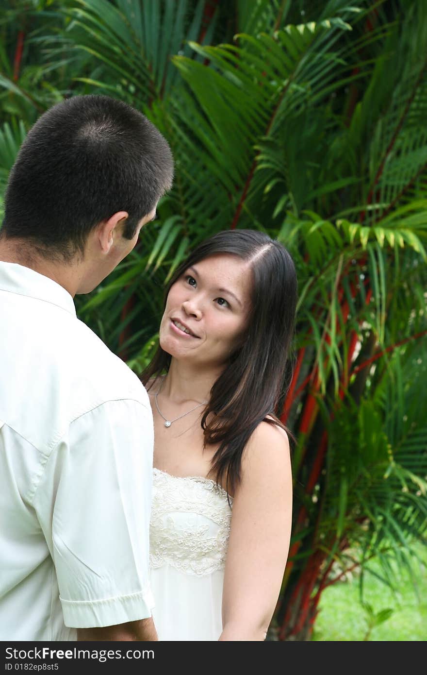 Happy bride and groom in a garden. Happy bride and groom in a garden.