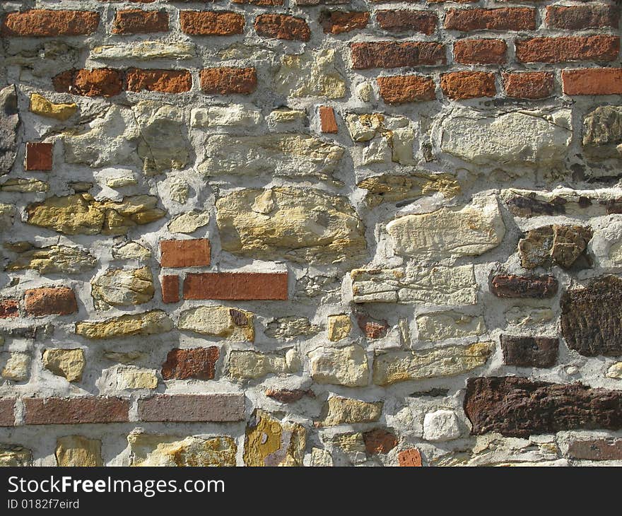 Wall made of briks and stones background. Wall made of briks and stones background