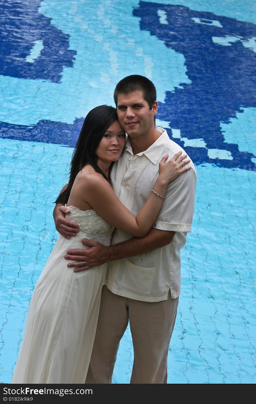 Bride and groom at the swimming pool - trash the dress trend. Bride and groom at the swimming pool - trash the dress trend.