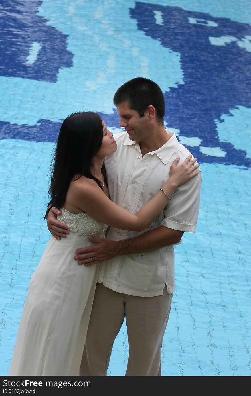 Bride and groom at the swimming pool - trash the dress trend. Bride and groom at the swimming pool - trash the dress trend.