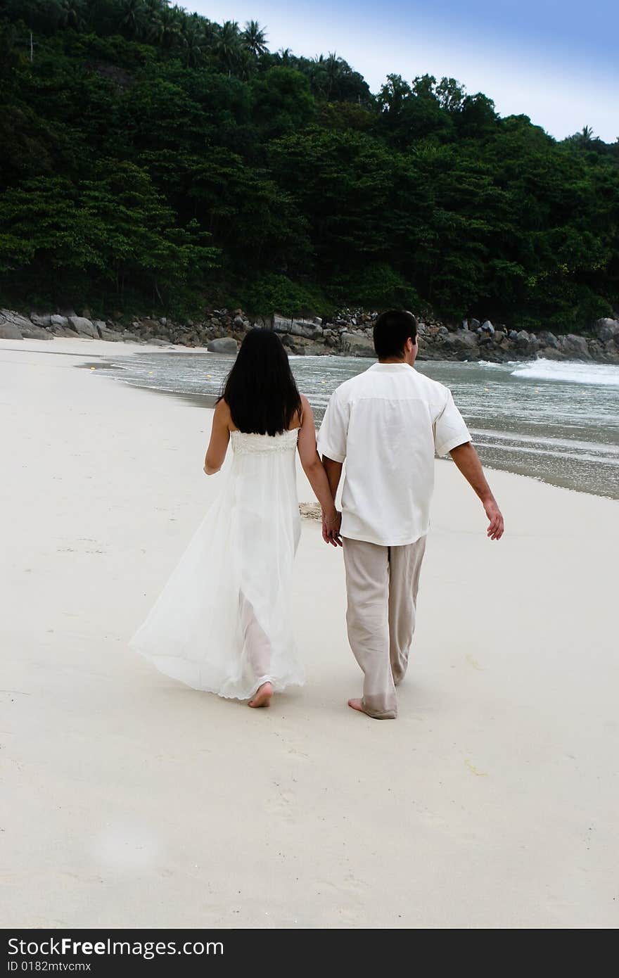 Portrait of an attractive bride and groom on the beach. Portrait of an attractive bride and groom on the beach.