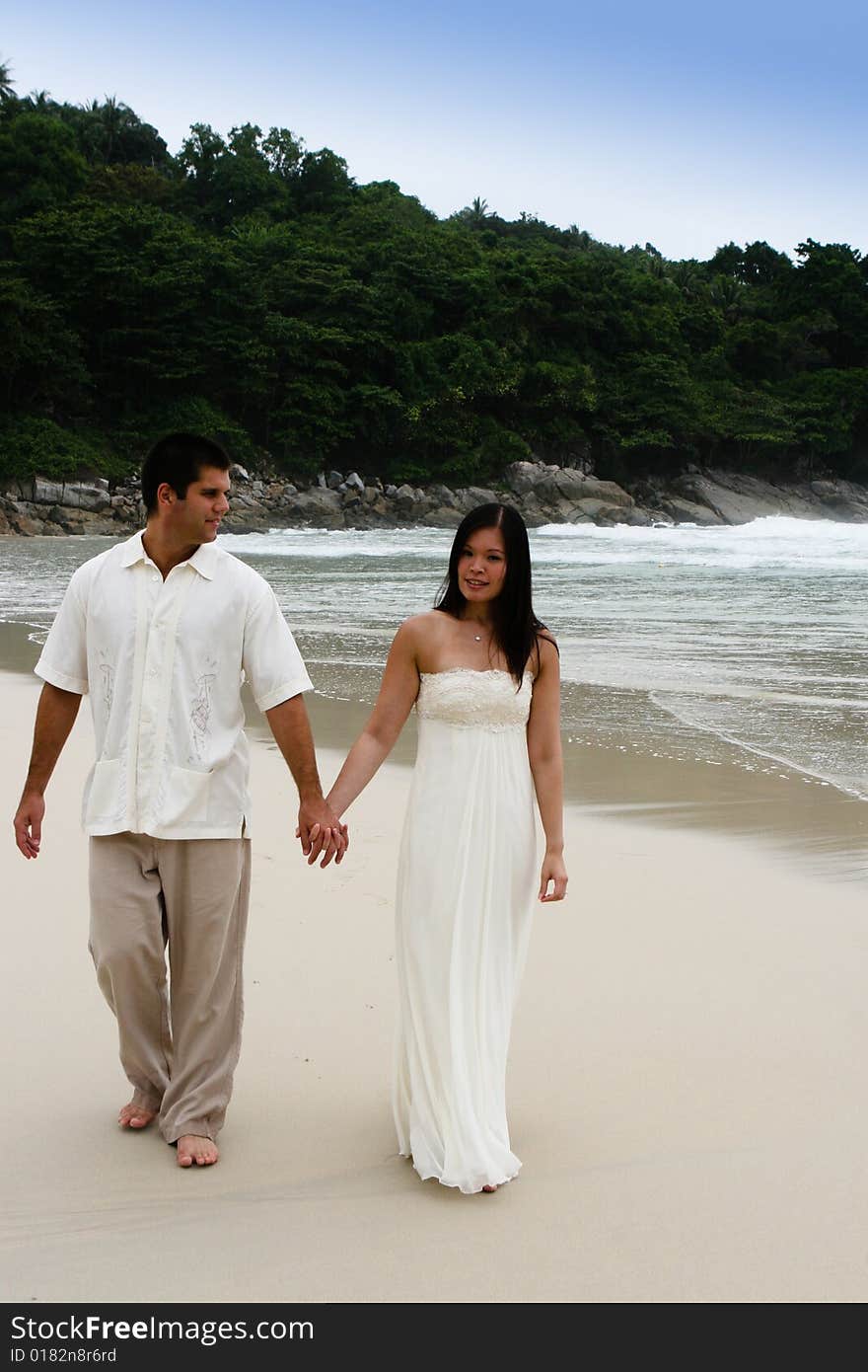 Portrait of an attractive bride and groom on the beach. Portrait of an attractive bride and groom on the beach.