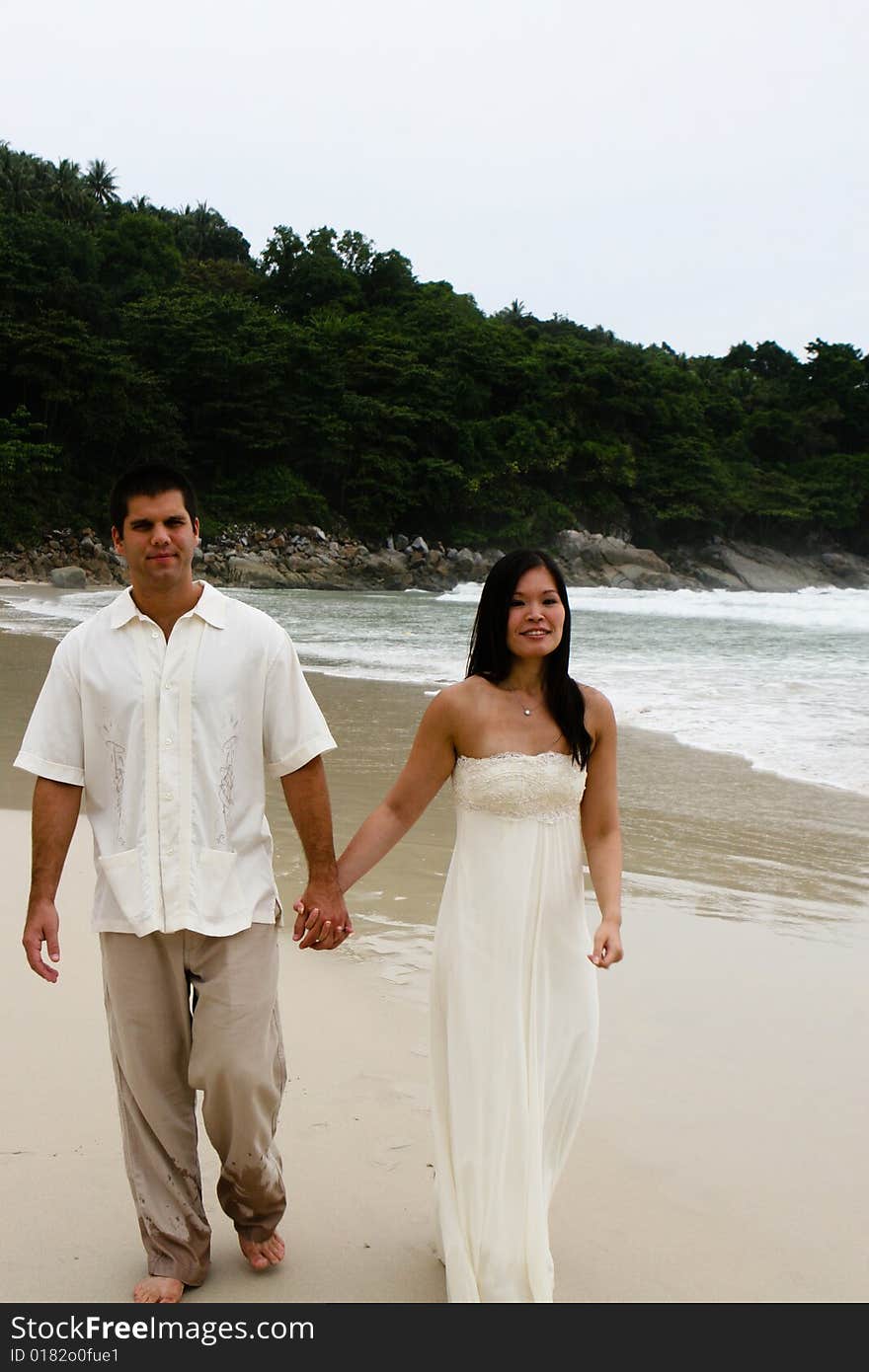 Portrait of an attractive bride and groom on the beach. Portrait of an attractive bride and groom on the beach.