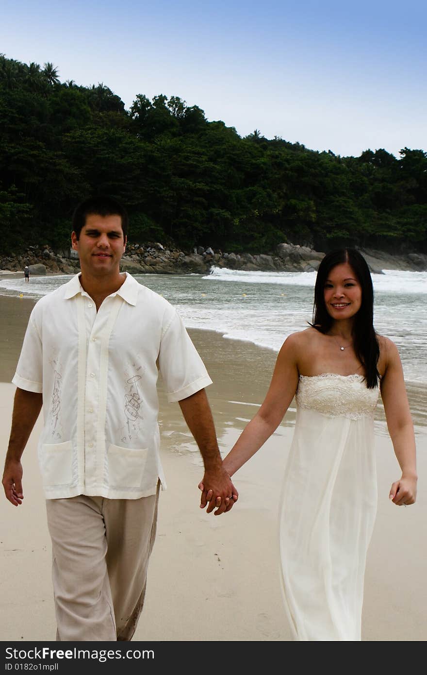 Portrait of an attractive bride and groom on the beach. Portrait of an attractive bride and groom on the beach.