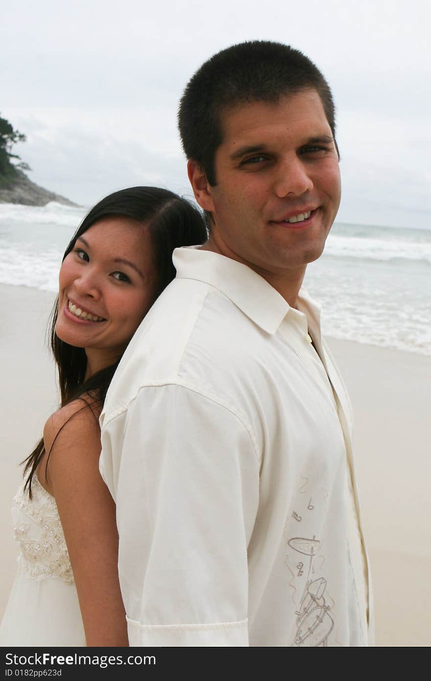 Portrait of an attractive bride and groom on the beach. Portrait of an attractive bride and groom on the beach.