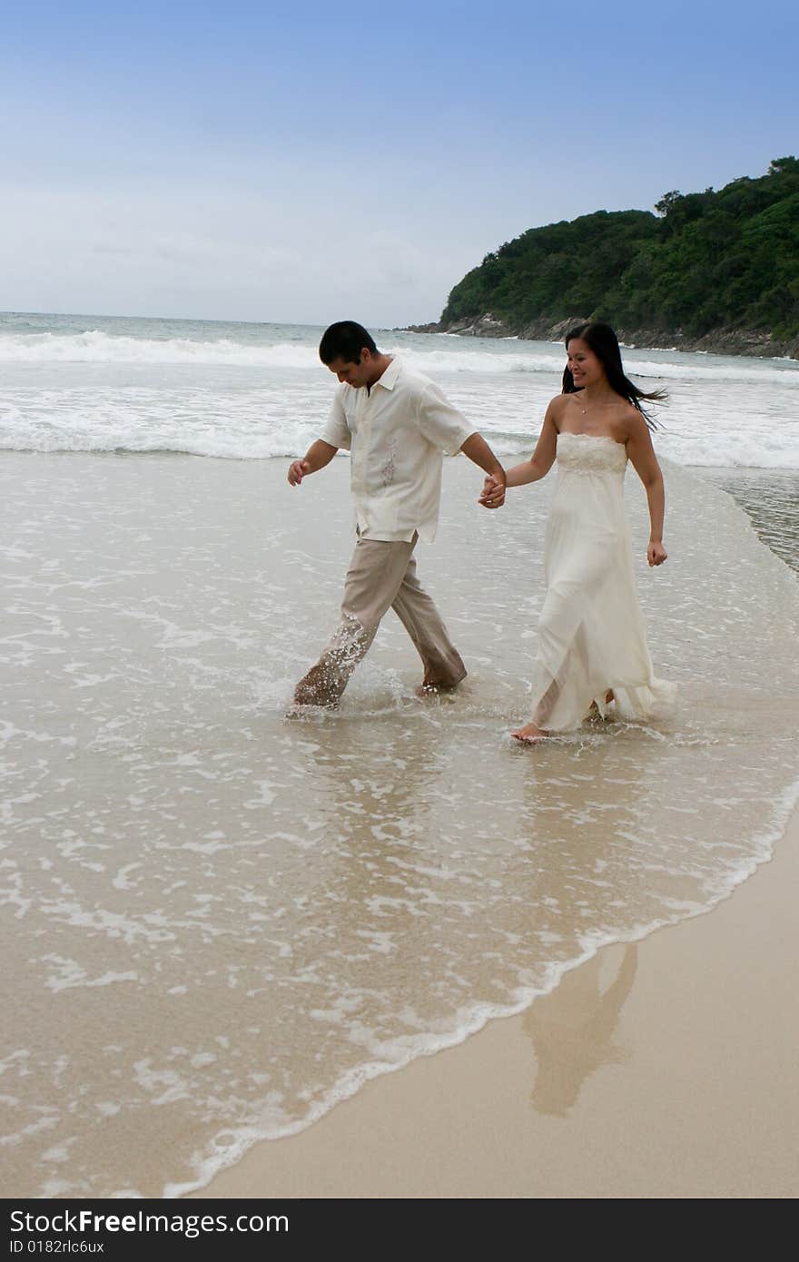 Portrait of an attractive bride and groom on the beach. Portrait of an attractive bride and groom on the beach.