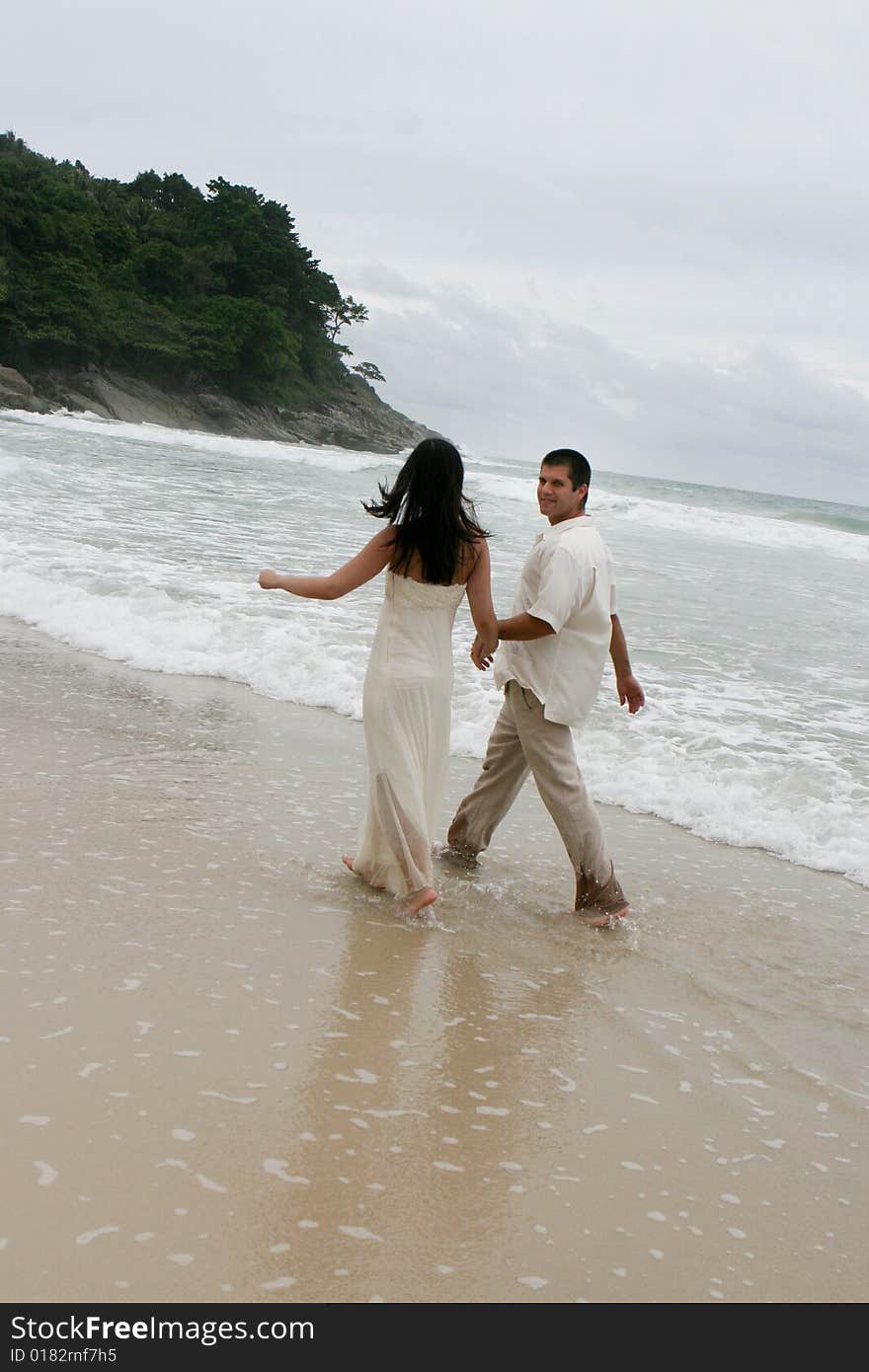 Portrait of an attractive bride and groom on the beach. Portrait of an attractive bride and groom on the beach.