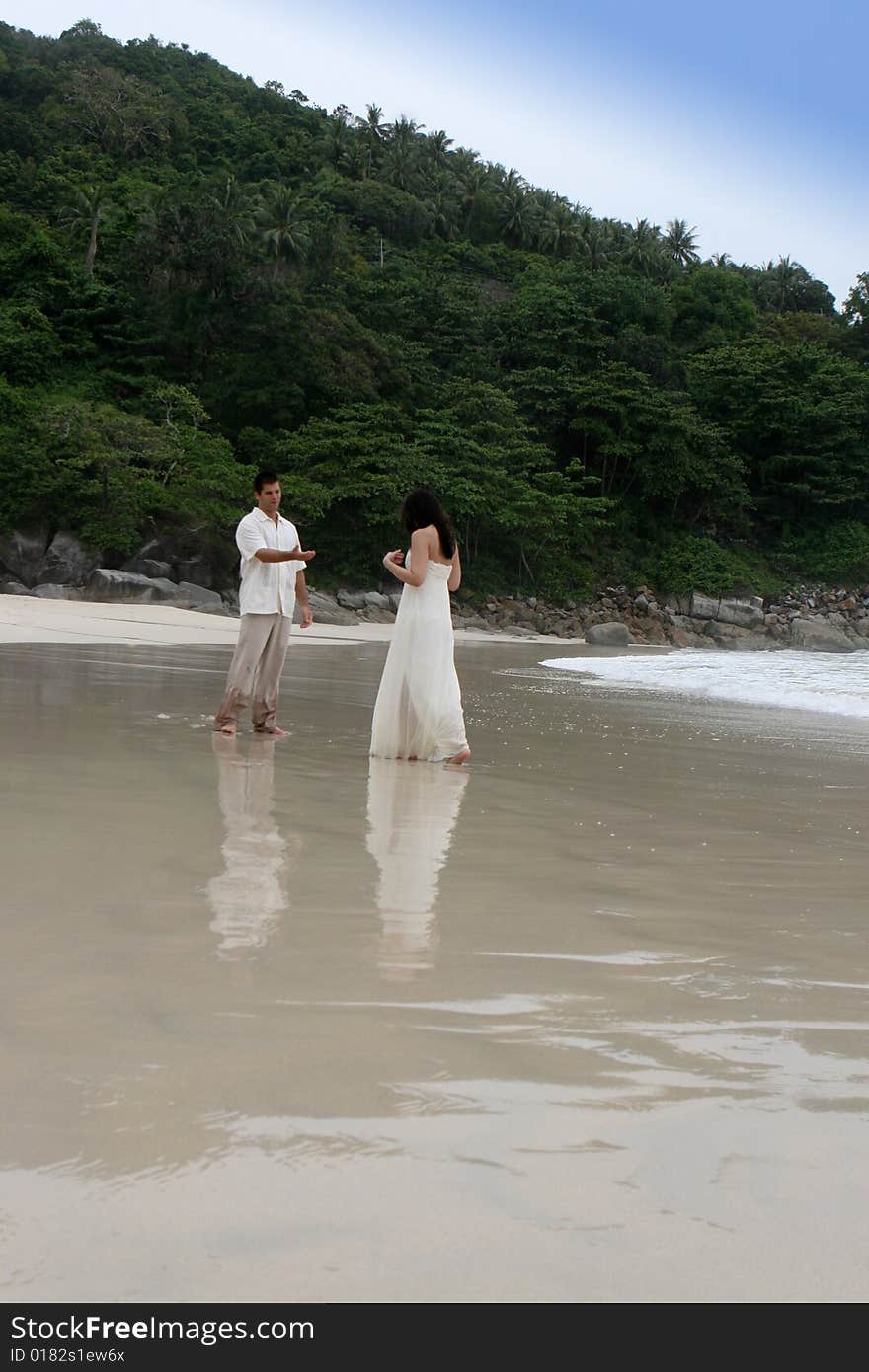 Portrait of an attractive bride and groom on the beach. Portrait of an attractive bride and groom on the beach.