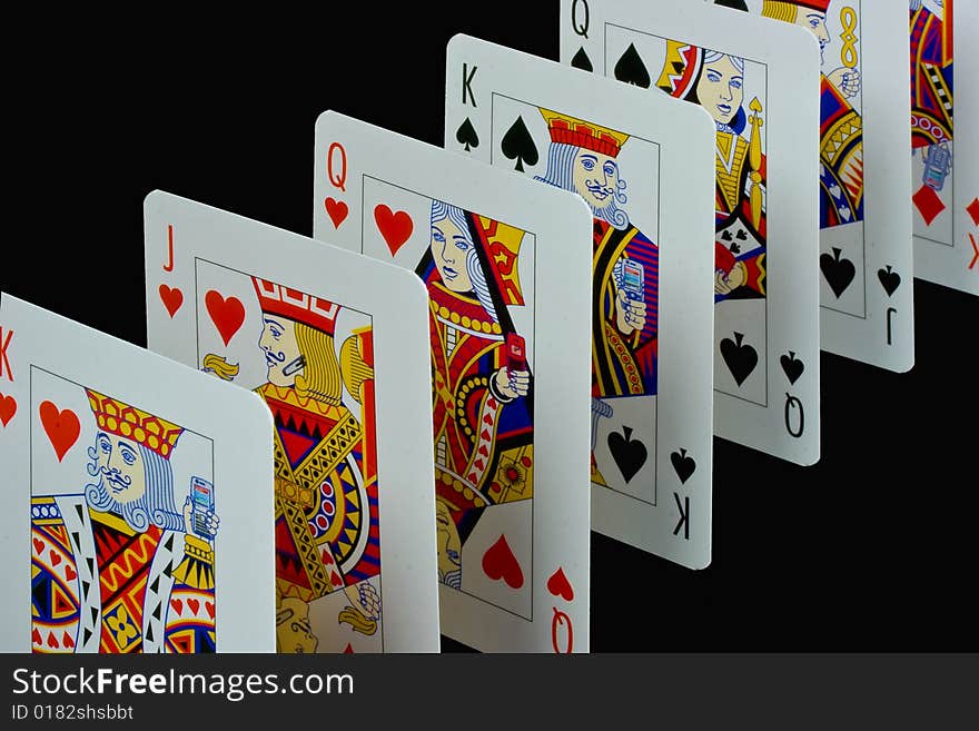 Playing cards standing, isolated on black