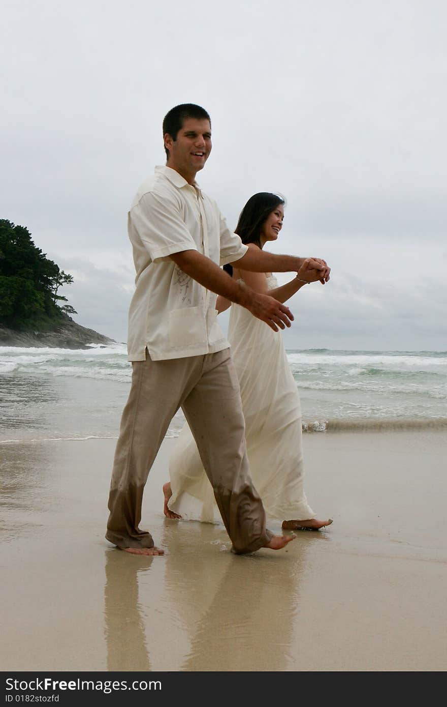 Portrait of an attractive bride and groom on the beach. Portrait of an attractive bride and groom on the beach.