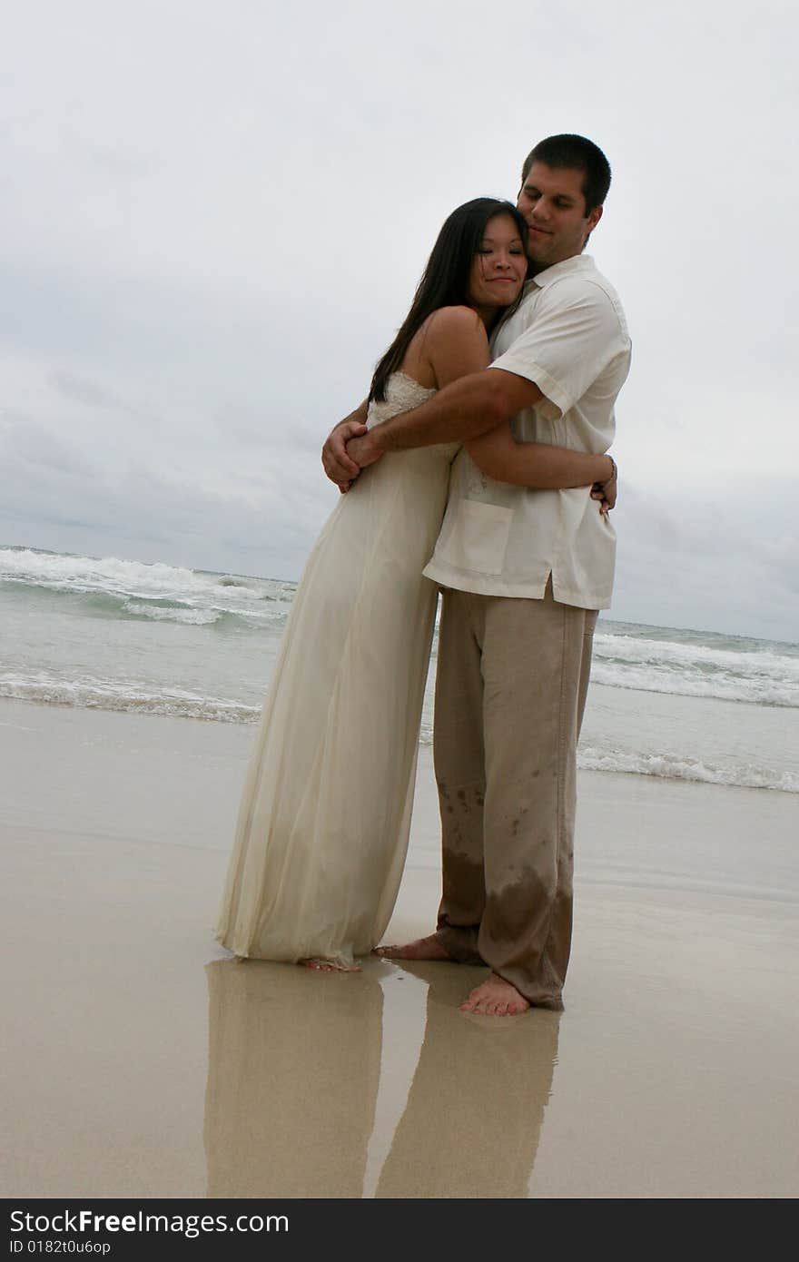 Portrait of an attractive bride and groom on the beach. Portrait of an attractive bride and groom on the beach.