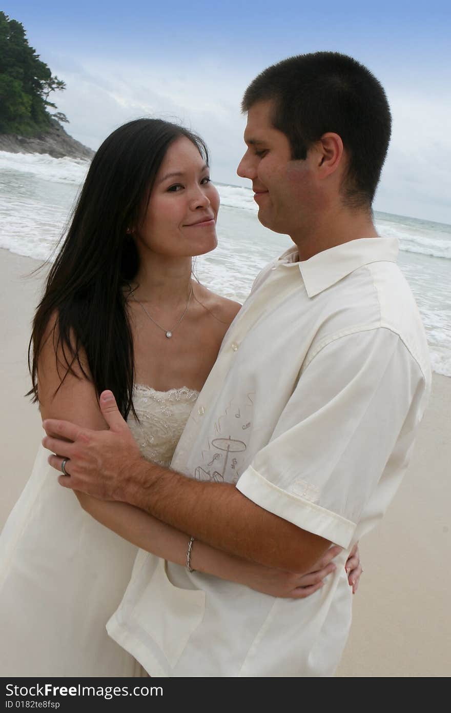 Portrait of an attractive bride and groom on the beach. Portrait of an attractive bride and groom on the beach.