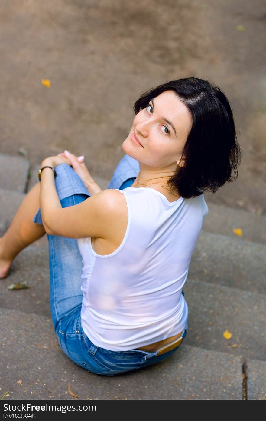 Pretty woman sitting on a staircase