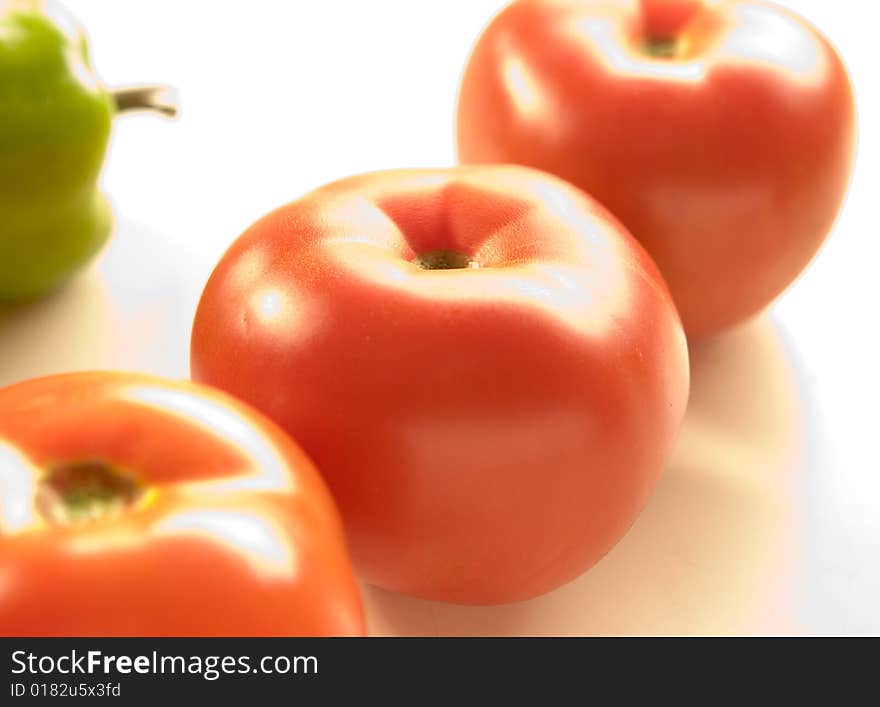 Red tomatoes on white ground