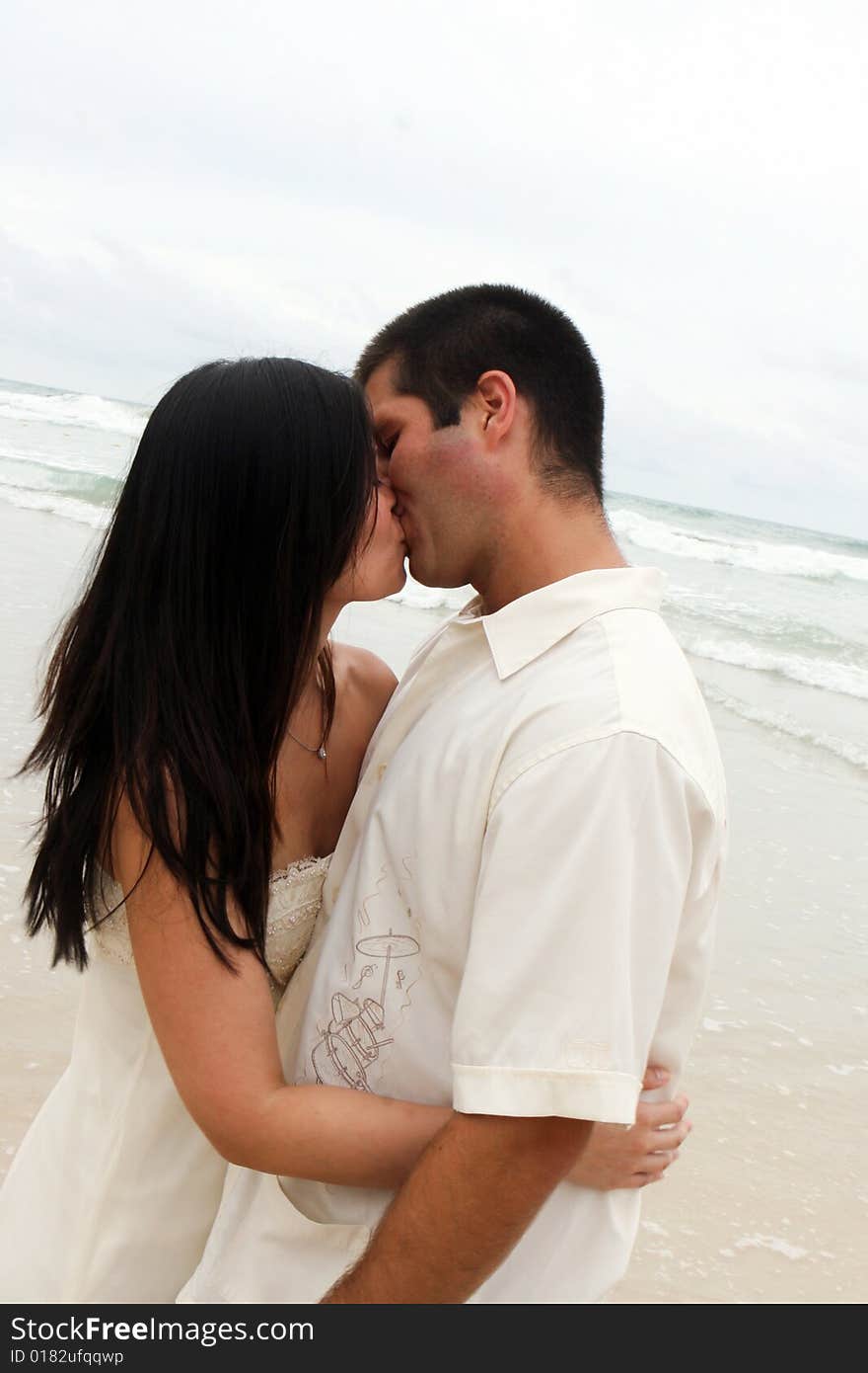 Portrait of an attractive bride and groom on the beach. Portrait of an attractive bride and groom on the beach.