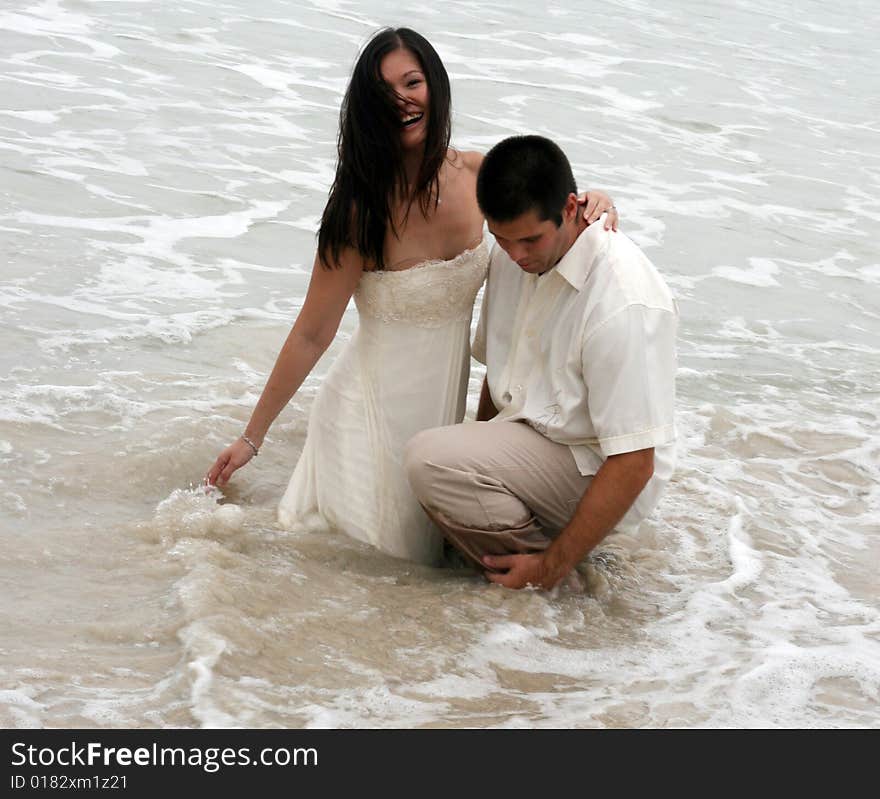 Portrait of an attractive bride and groom on the beach. Portrait of an attractive bride and groom on the beach.