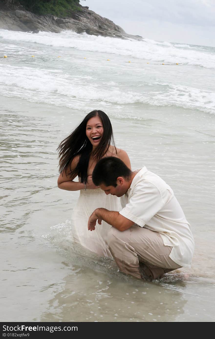 Portrait of an attractive bride and groom on the beach. Portrait of an attractive bride and groom on the beach.