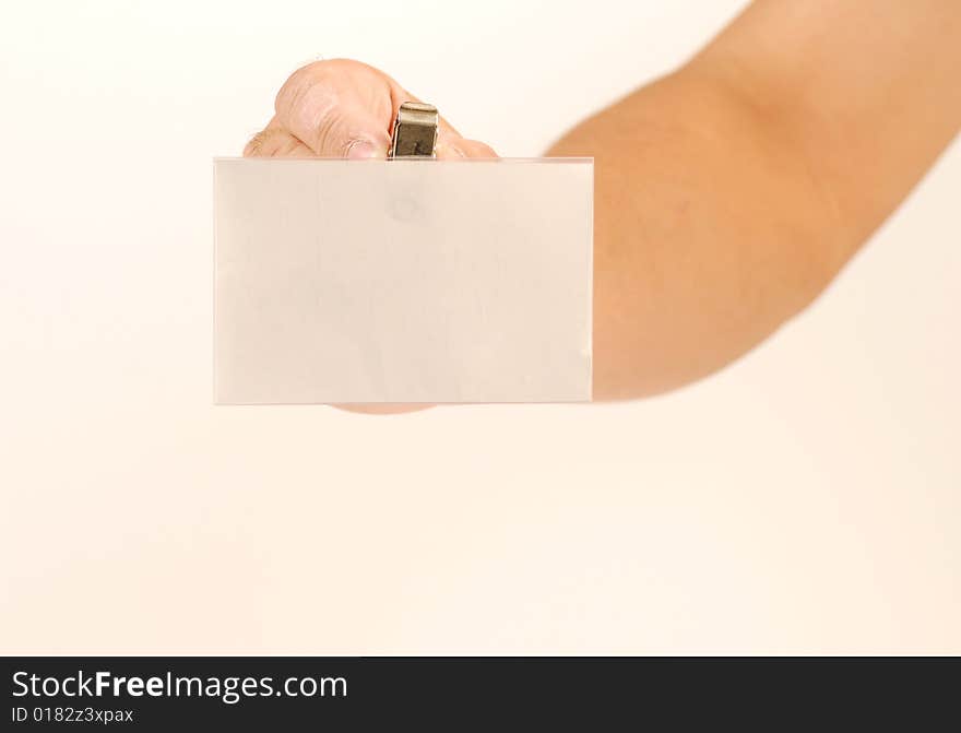 Hand holding a blank white card with metal clip. Hand holding a blank white card with metal clip.