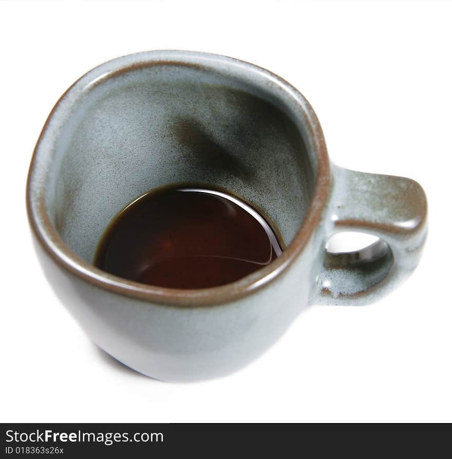 Looking down into a coffee cup with only a bit of coffee left down at the bottom, isolated on white. Looking down into a coffee cup with only a bit of coffee left down at the bottom, isolated on white.