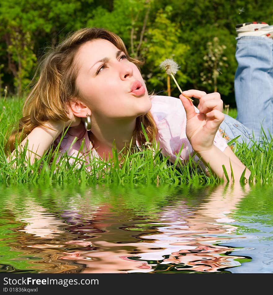 Girl blowing on the dandelion