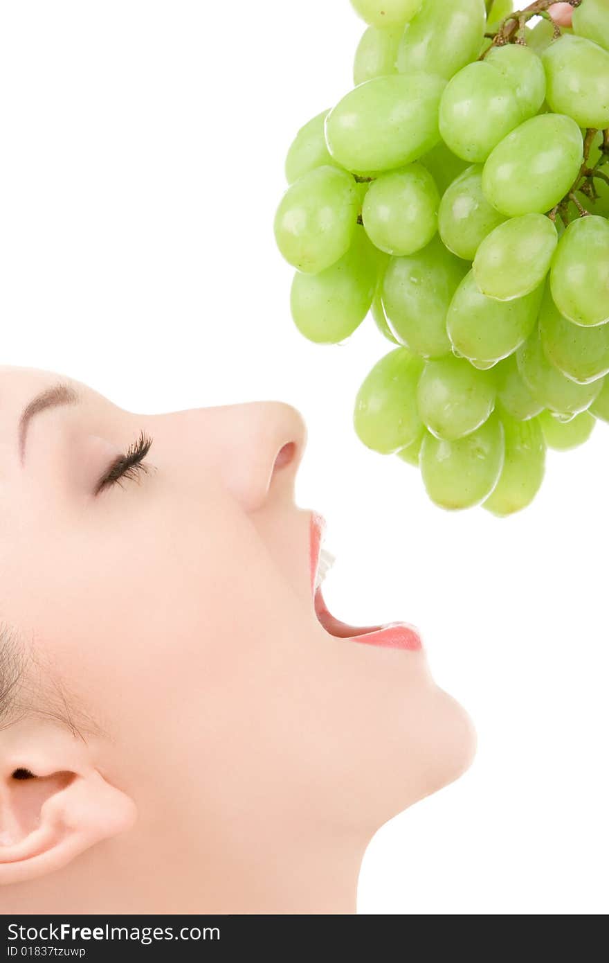 Pretty woman with green grape isolated on the white background