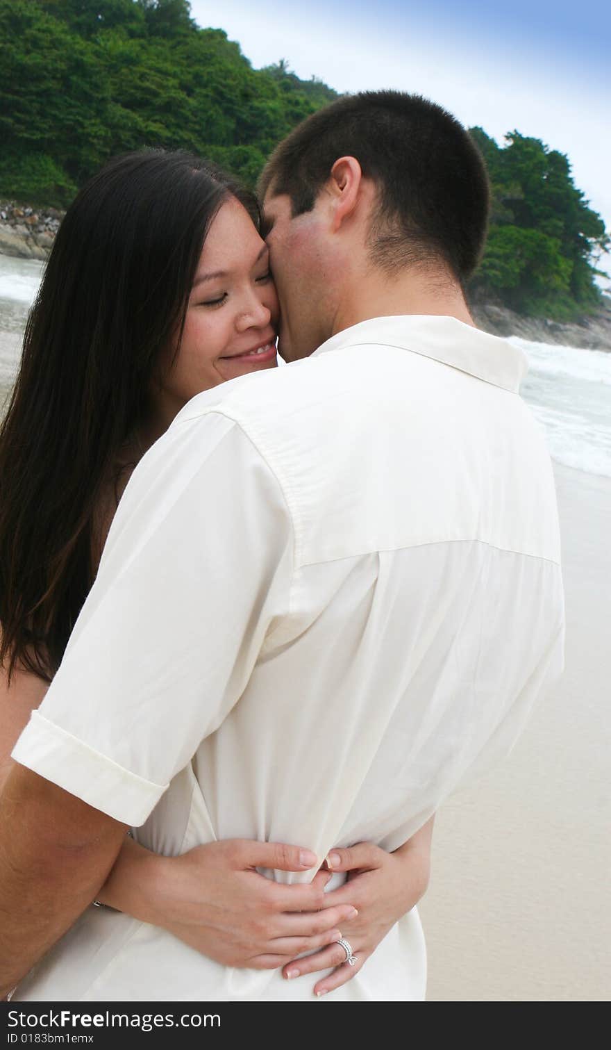 Portrait of an attractive bride and groom on the beach. Portrait of an attractive bride and groom on the beach.