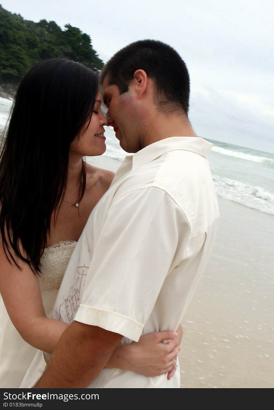 Portrait of an attractive bride and groom on the beach. Portrait of an attractive bride and groom on the beach.