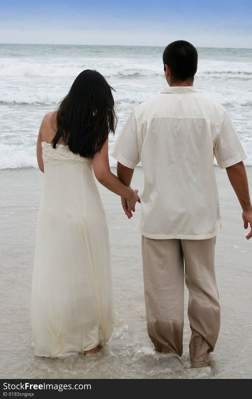 Portrait of an attractive bride and groom on the beach. Portrait of an attractive bride and groom on the beach.