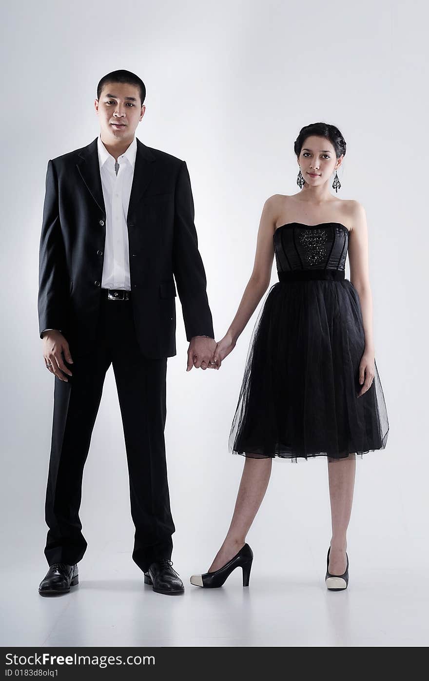 Couple holding hand on a plain white background