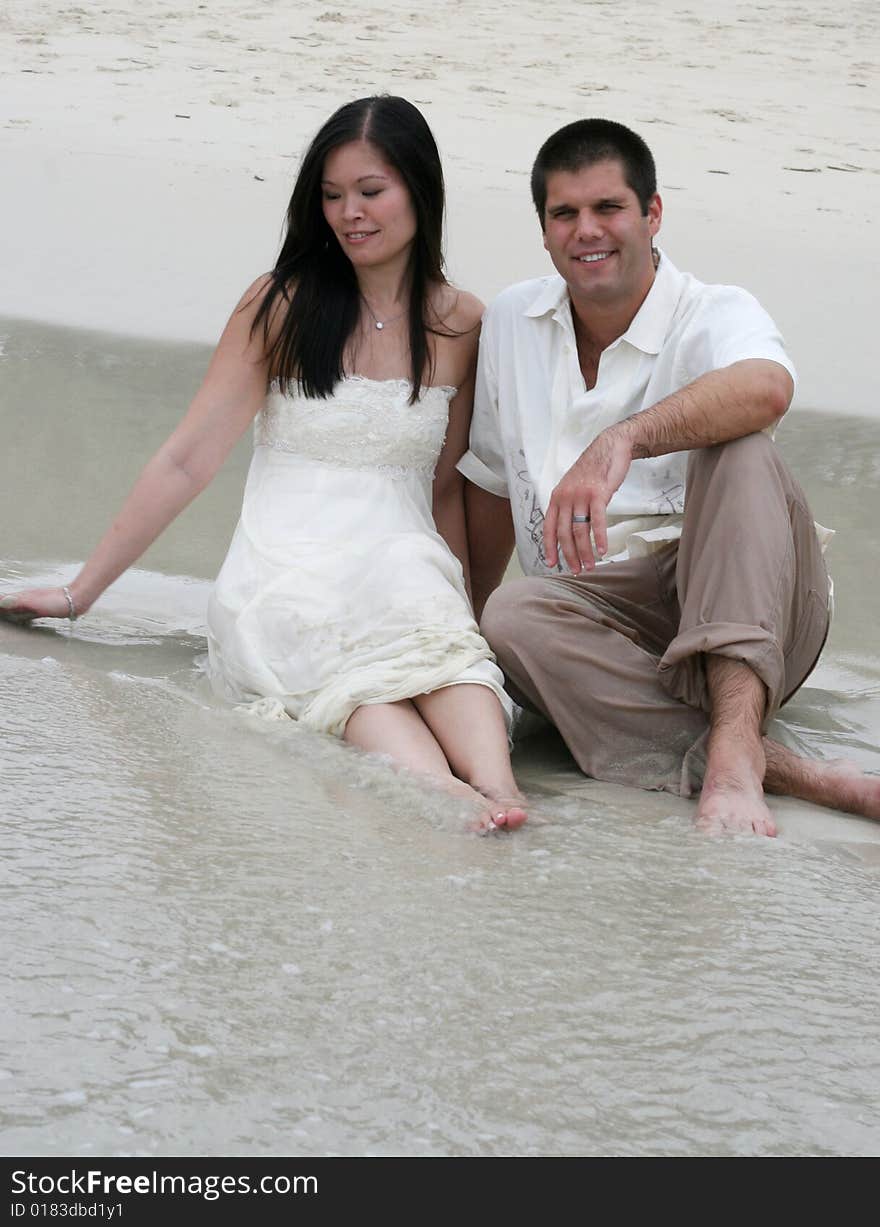 Portrait of an attractive bride and groom on the beach. Portrait of an attractive bride and groom on the beach.