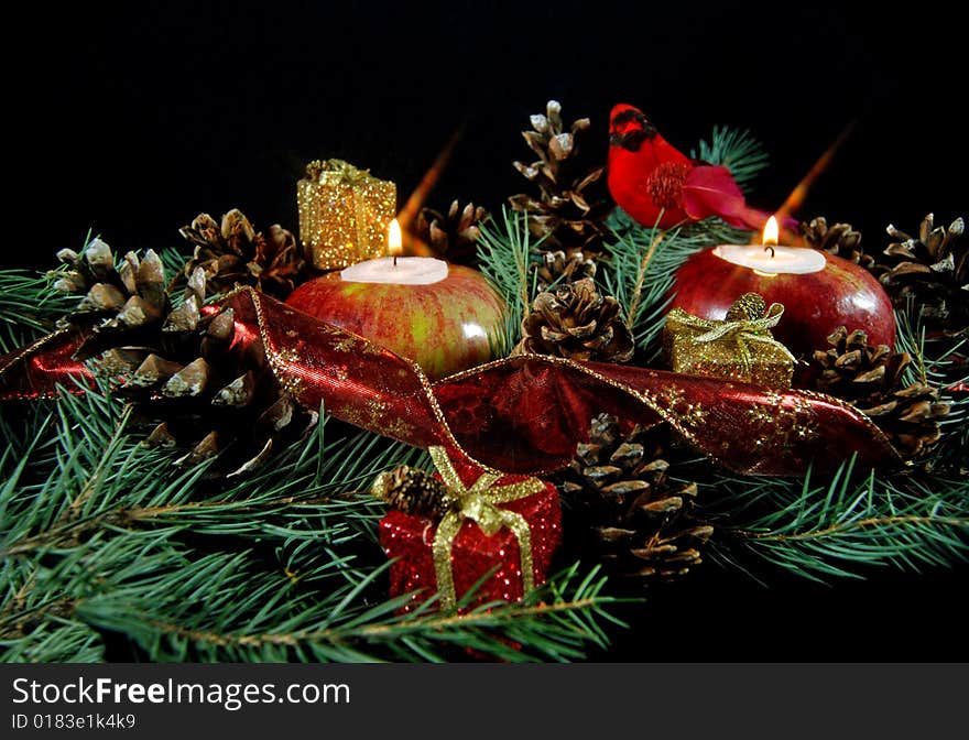 Glowing candles in apples with pine cones and cardinal. Glowing candles in apples with pine cones and cardinal.