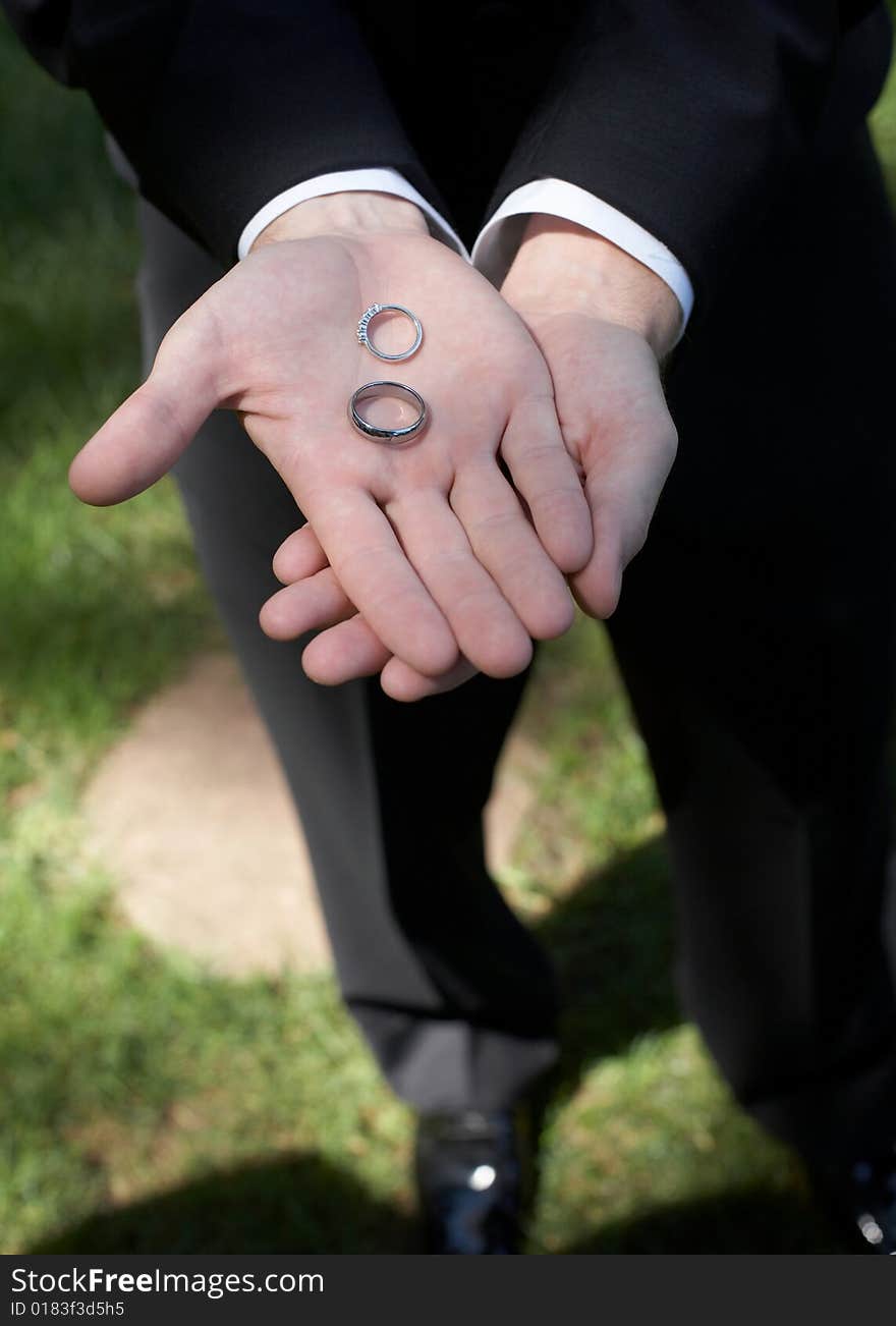 Hands holding wedding bands DOF focus on rings. Hands holding wedding bands DOF focus on rings