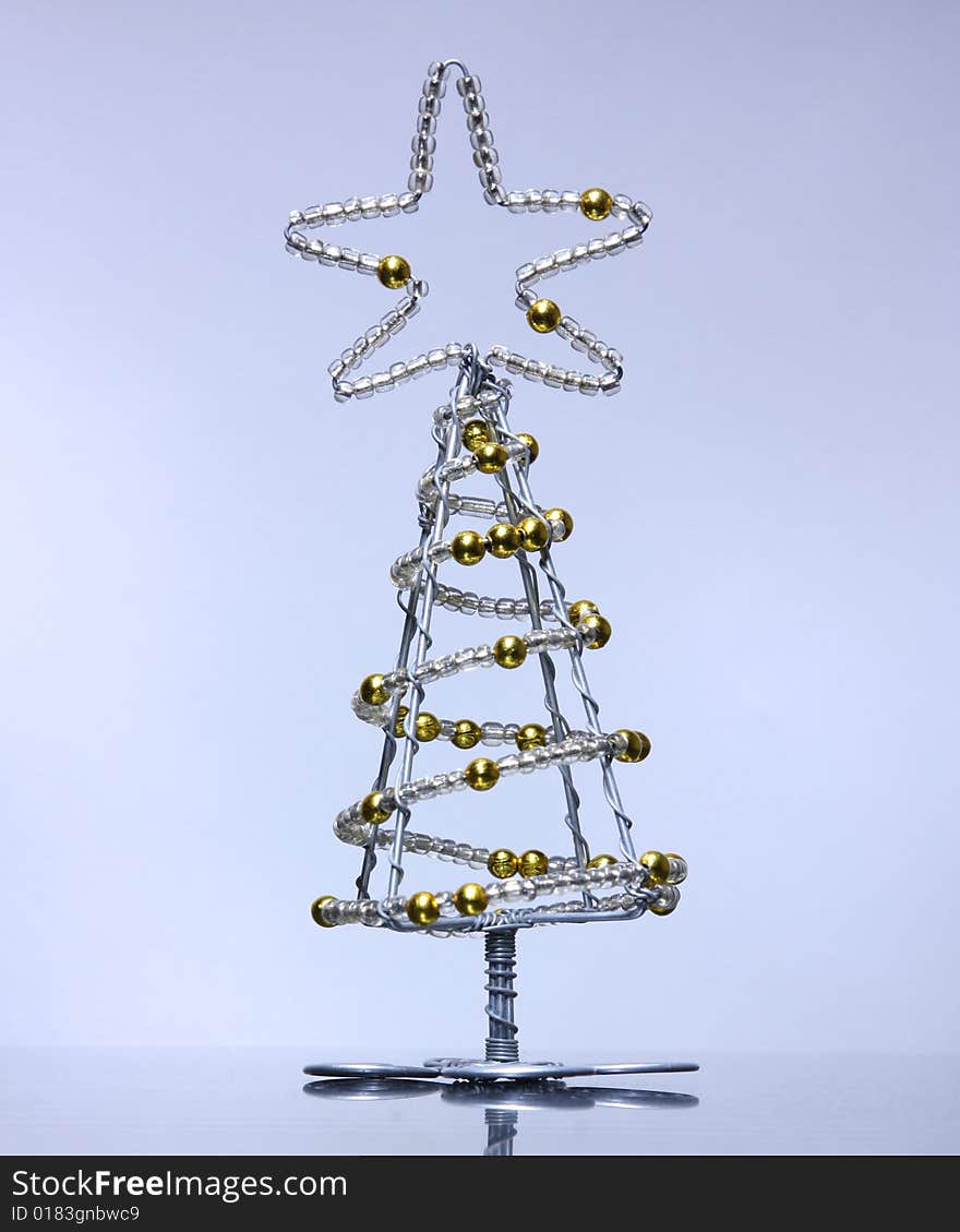 A Christmas tree made of wire and beads.