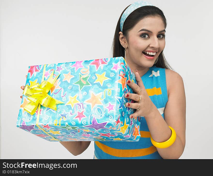 Asian girl of indian origin with a gift box. Asian girl of indian origin with a gift box