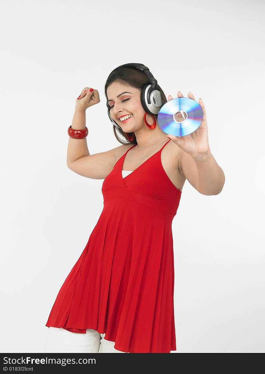 A sexy asian female of indian origin enjoying music. A sexy asian female of indian origin enjoying music