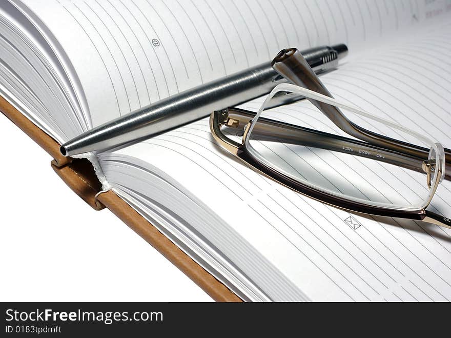 Steel Pen, Glasses And Agenda Organizer.