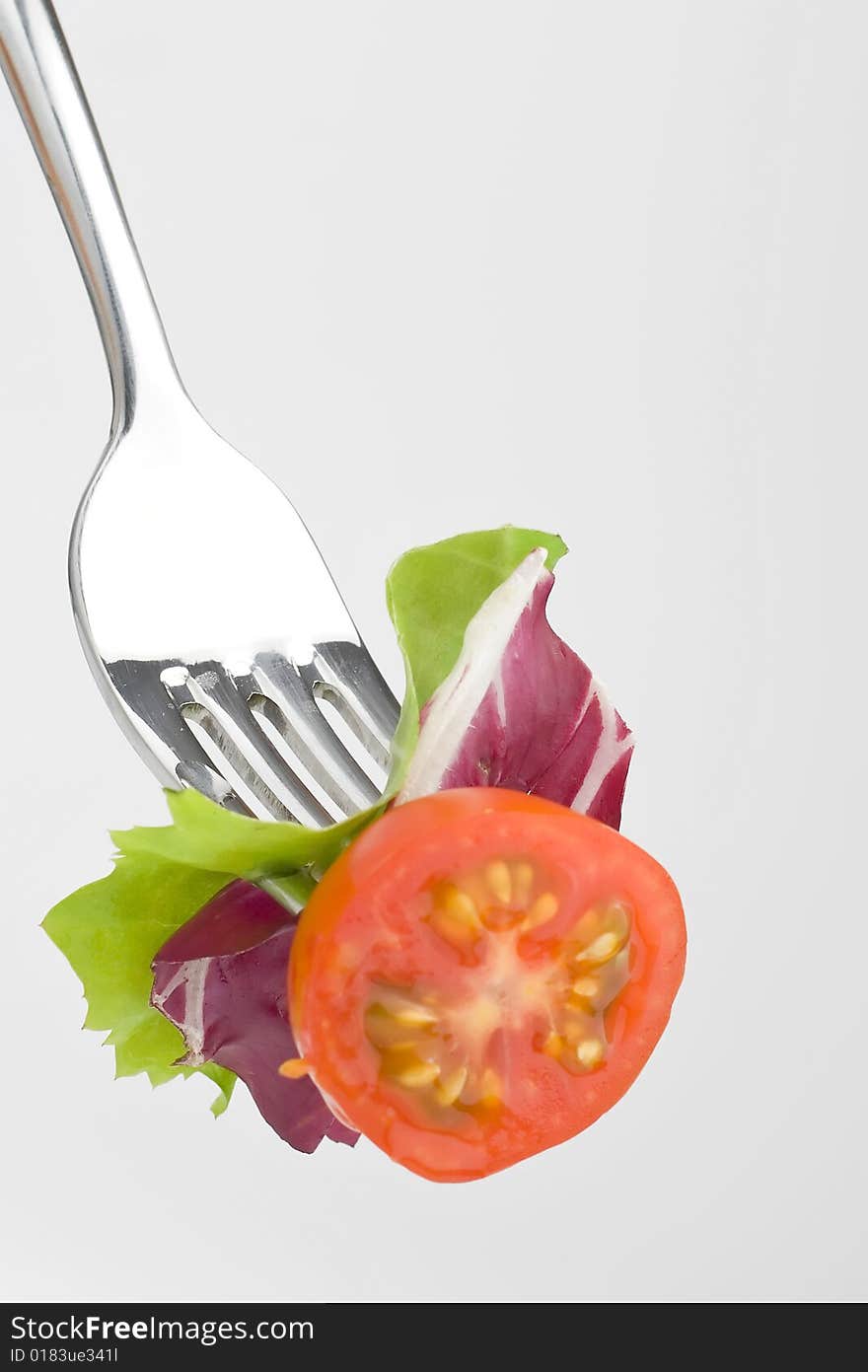 Fork with Fresh Salad isolated over white background. Fork with Fresh Salad isolated over white background