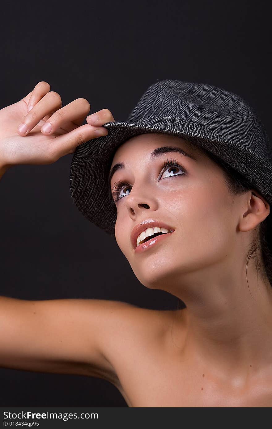 Young beautiful model posing with grey hat. Young beautiful model posing with grey hat