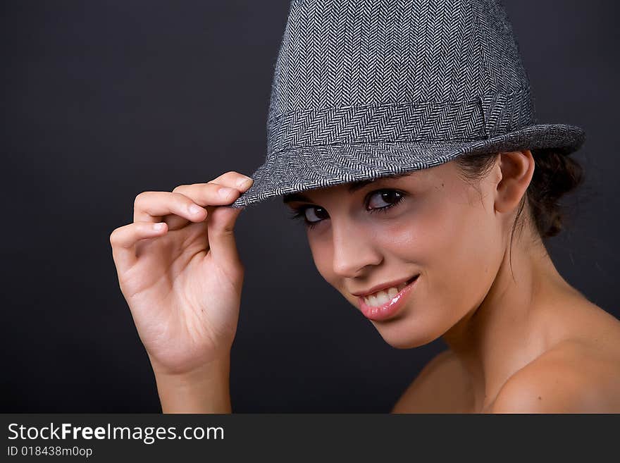 Young beautiful model posing with grey hat. Young beautiful model posing with grey hat