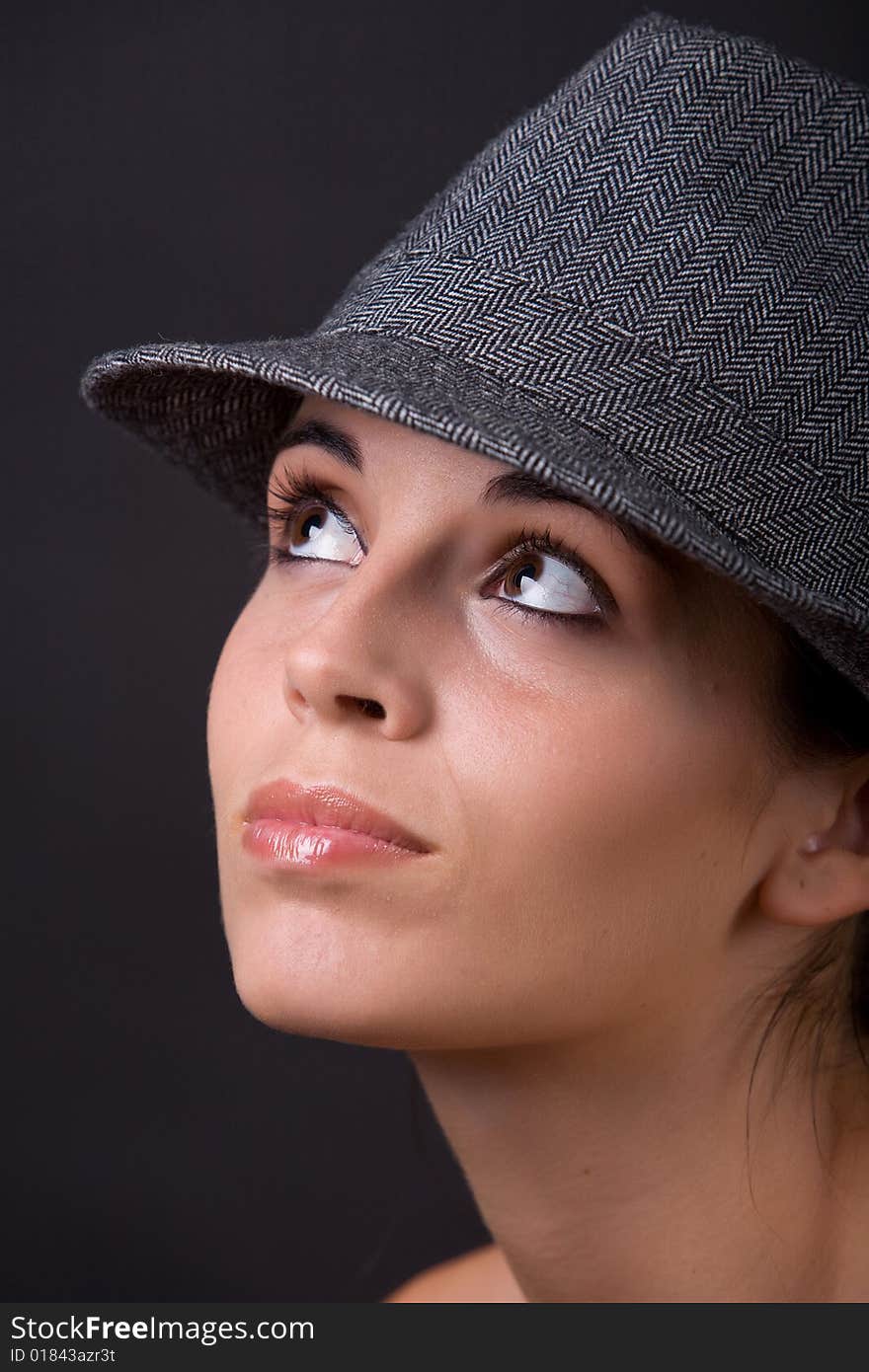 Young beautiful model posing with grey hat. Young beautiful model posing with grey hat