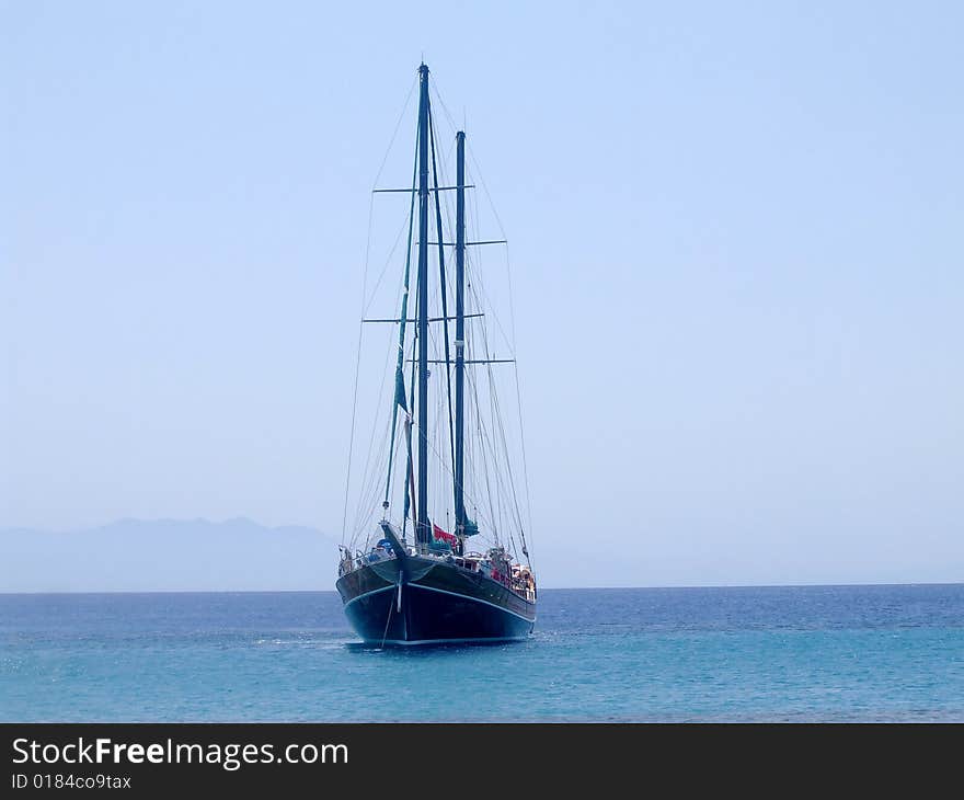 A yacht sailing off Paranga Beach, Mykonos, Greece. A yacht sailing off Paranga Beach, Mykonos, Greece