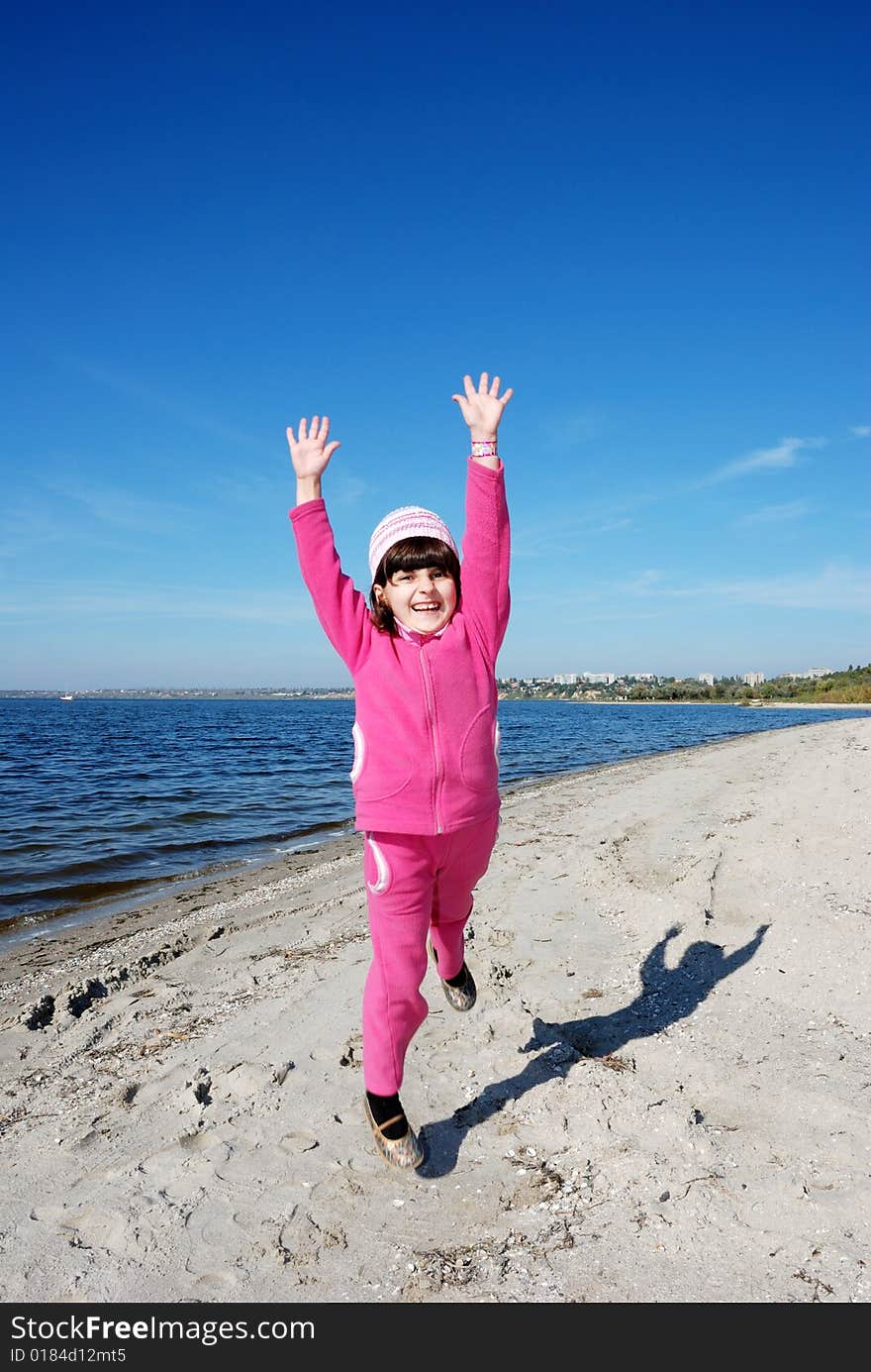 Running child on river shore