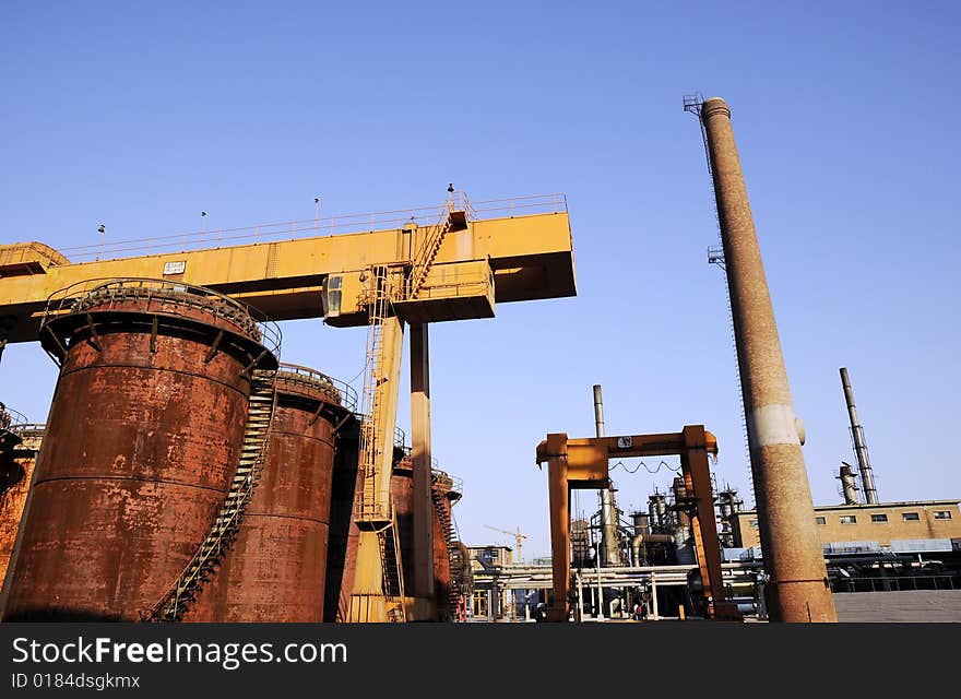 Crane, funnel and oil tanks in the factory. Crane, funnel and oil tanks in the factory