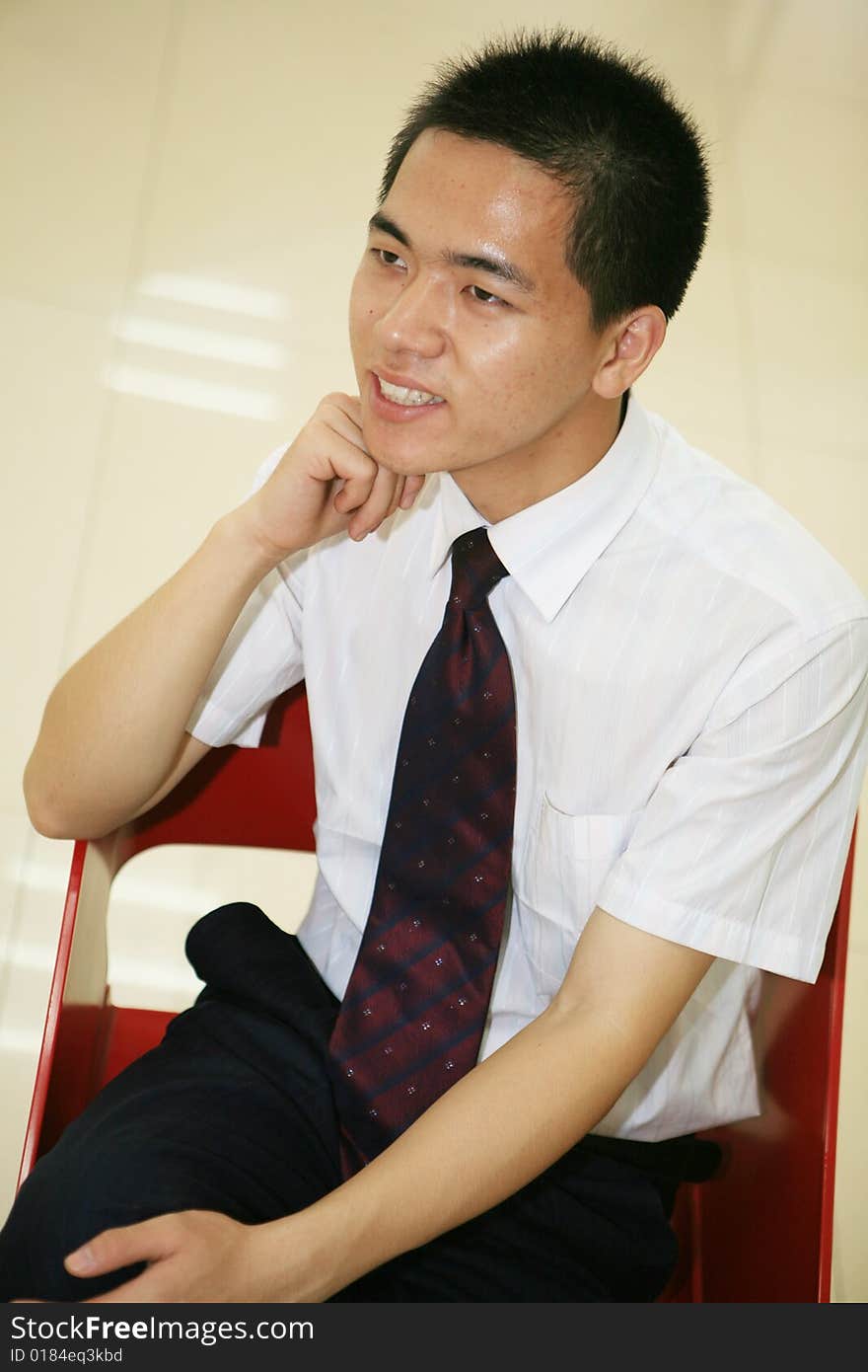 A young asian standing in office building. A young asian standing in office building