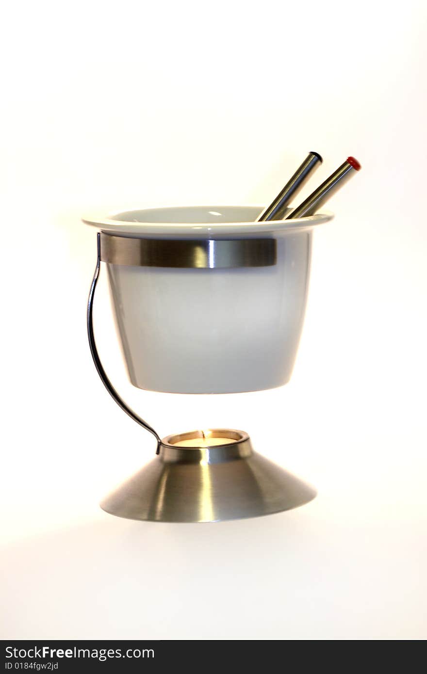 An isolated white fondue set.