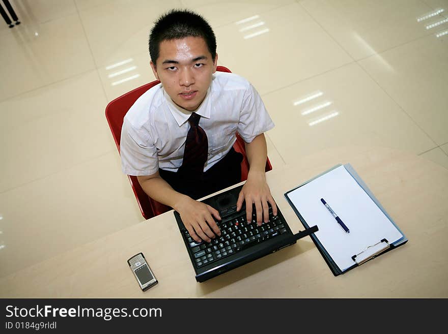 Young asian businessman in his office